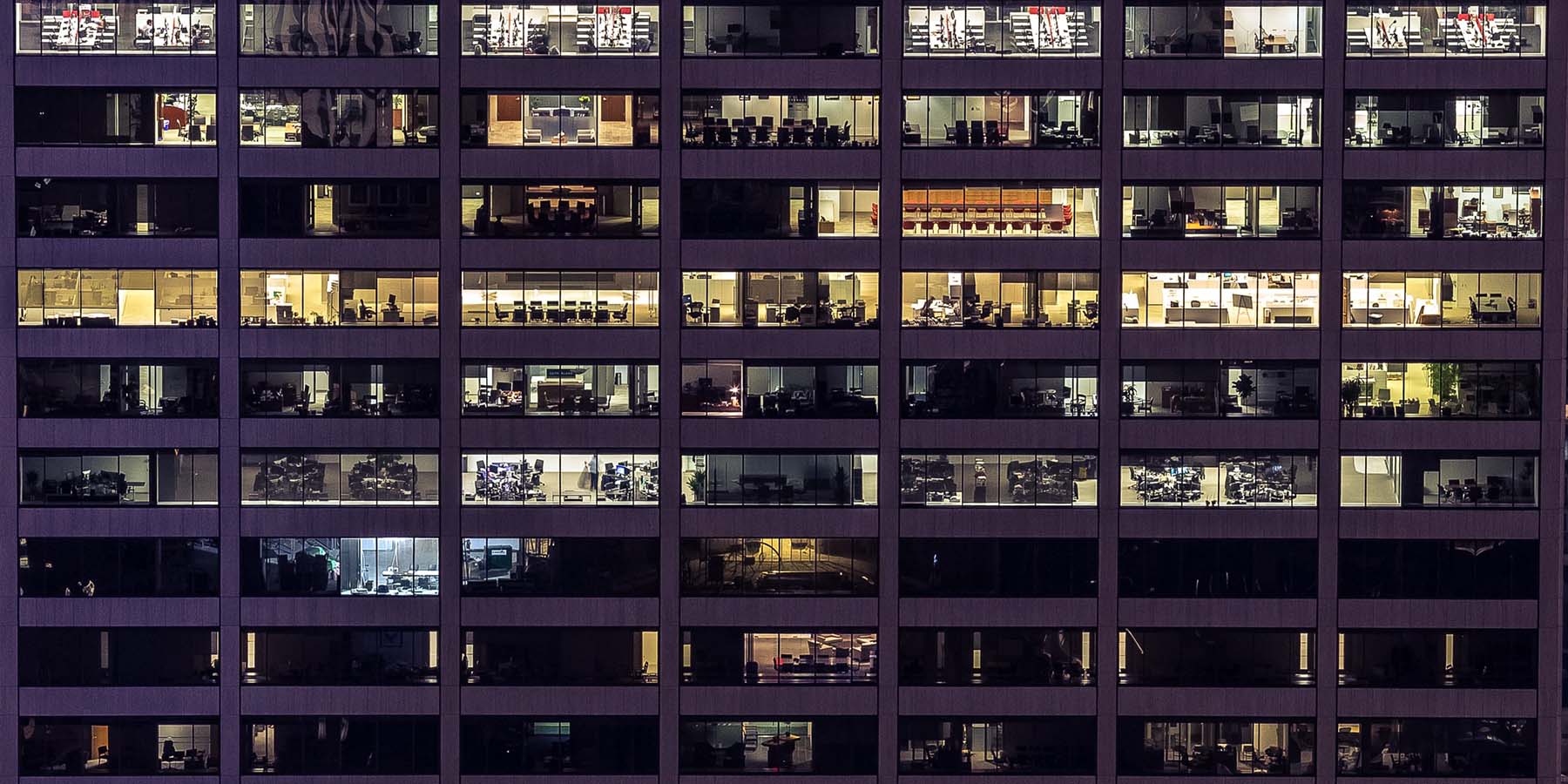 View of an office building in the evening with the lights on